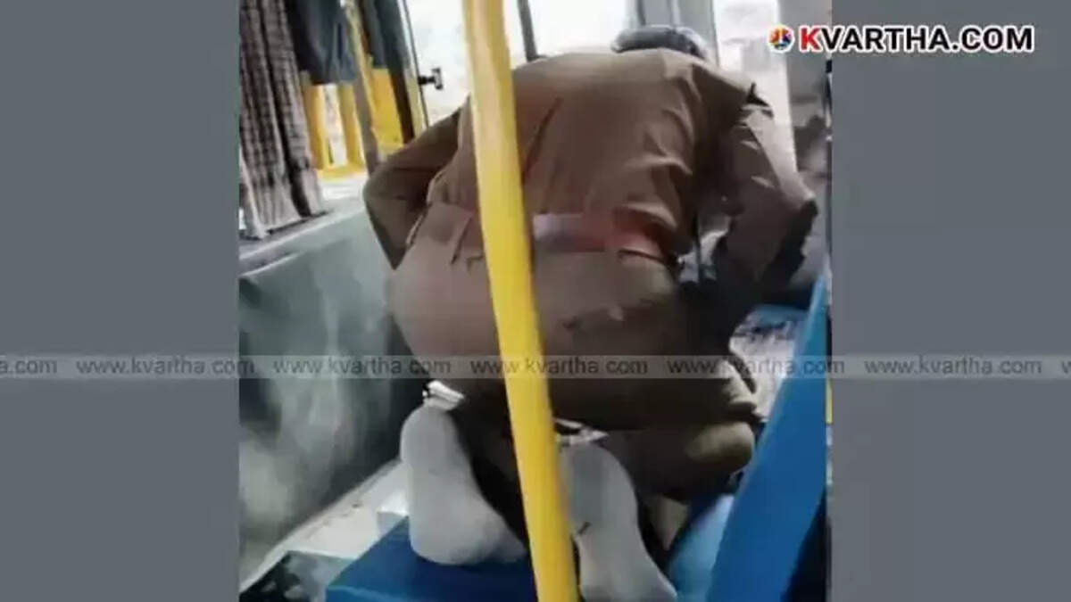 KSRTC bus driver offering prayers while seated in the passenger seat.